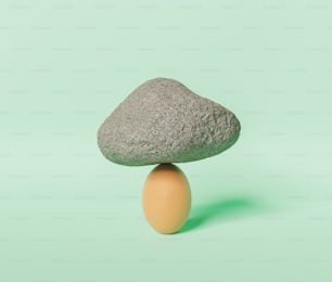 Scène minimaliste d’un œuf avec un rocher lourd sur fond pastel. Rendu 3D