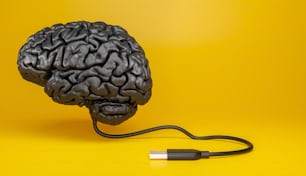 representação de um cérebro humano feito de material escuro com cabo USB conectado em fundo amarelo. Ilustração 3d