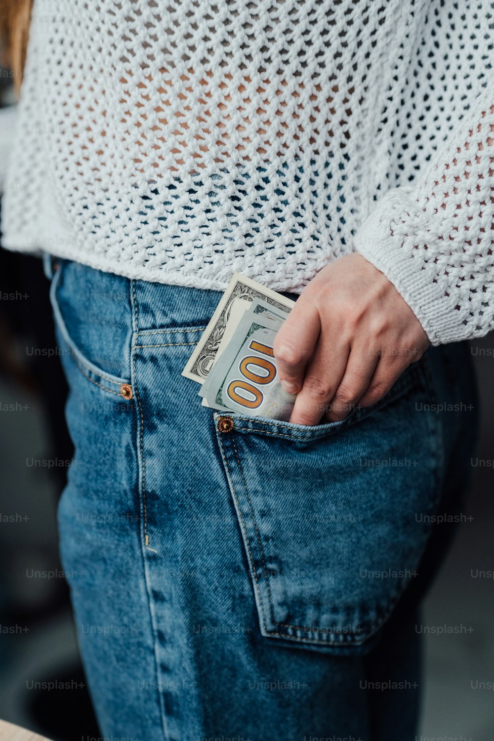 a woman is holding a money in her pocket