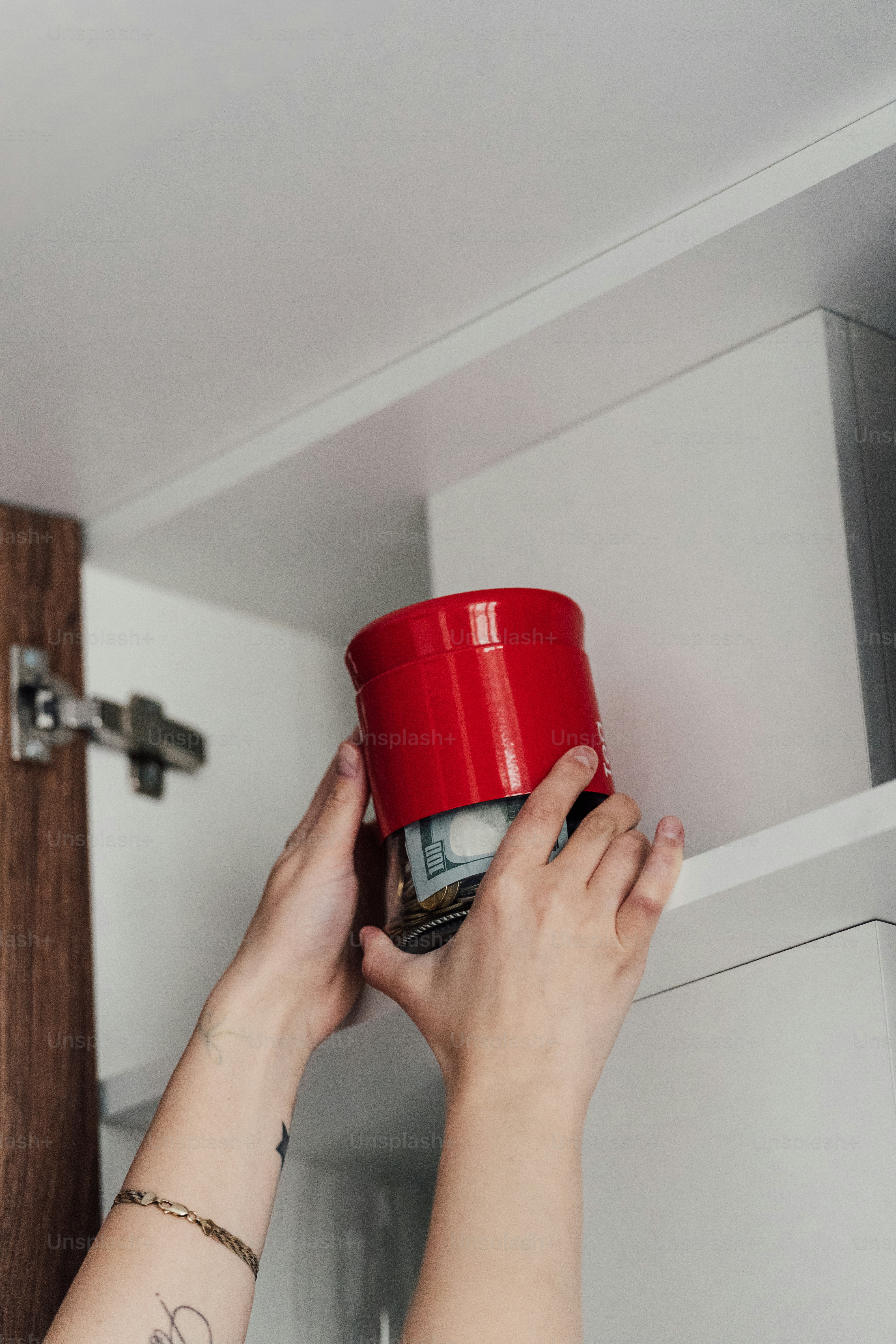 a woman is holding a red cup in her hand