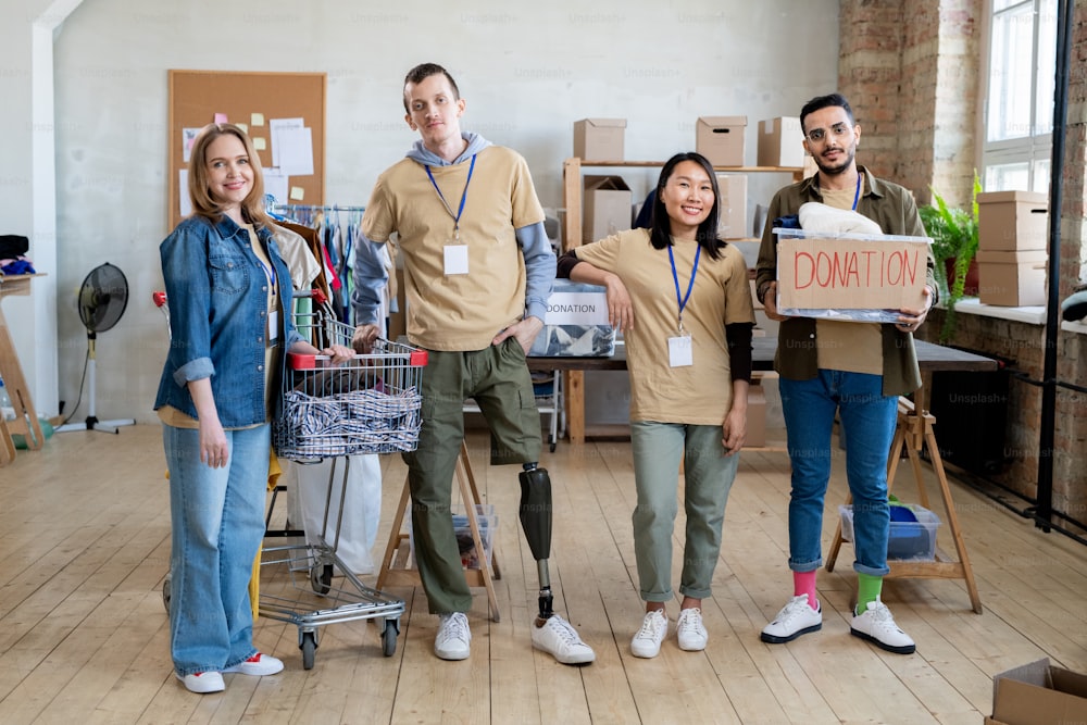 A group of people with donation clothes standing in office