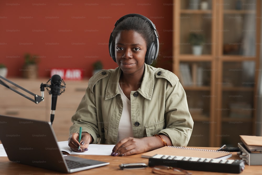 Portrait of female African-American musician looking at camera while composing at home, copy space