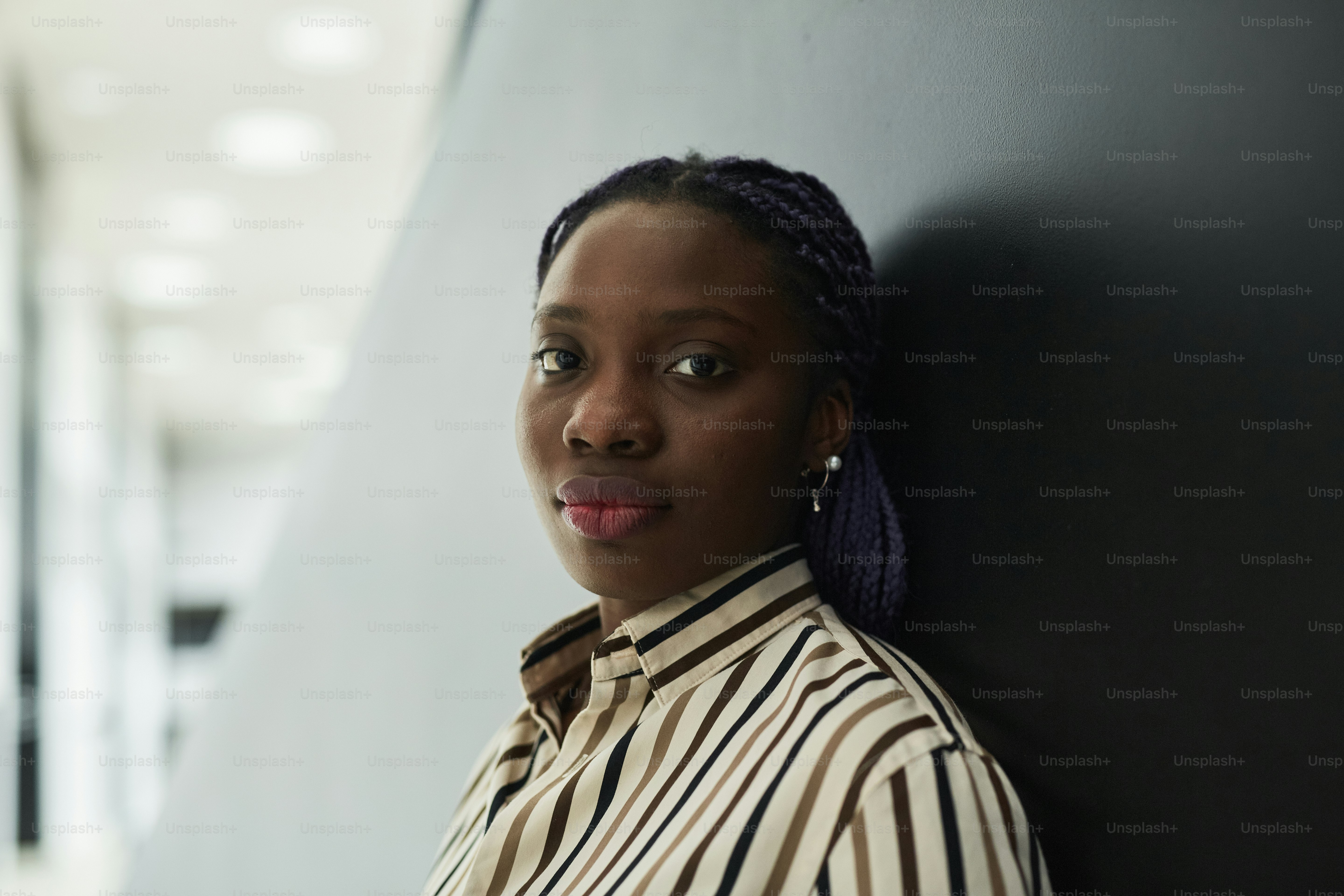 Close up portrait of young African-American businesswoman looking at ...