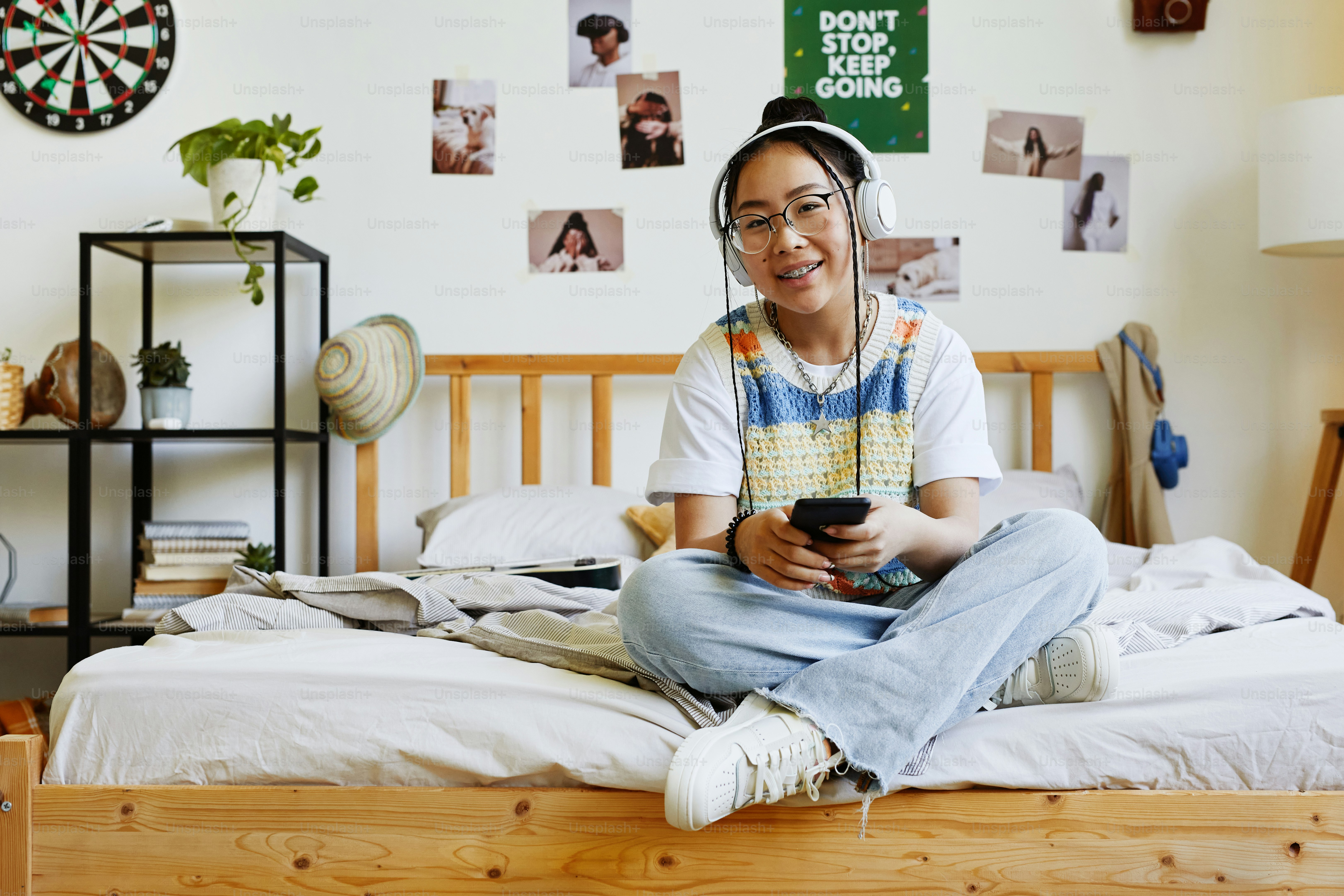 Portrait of modern teenage girl studying at desk at home and writing in ...
