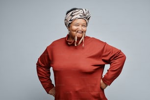 Waist up portrait of carefree black senior woman having fun against white background, copy space