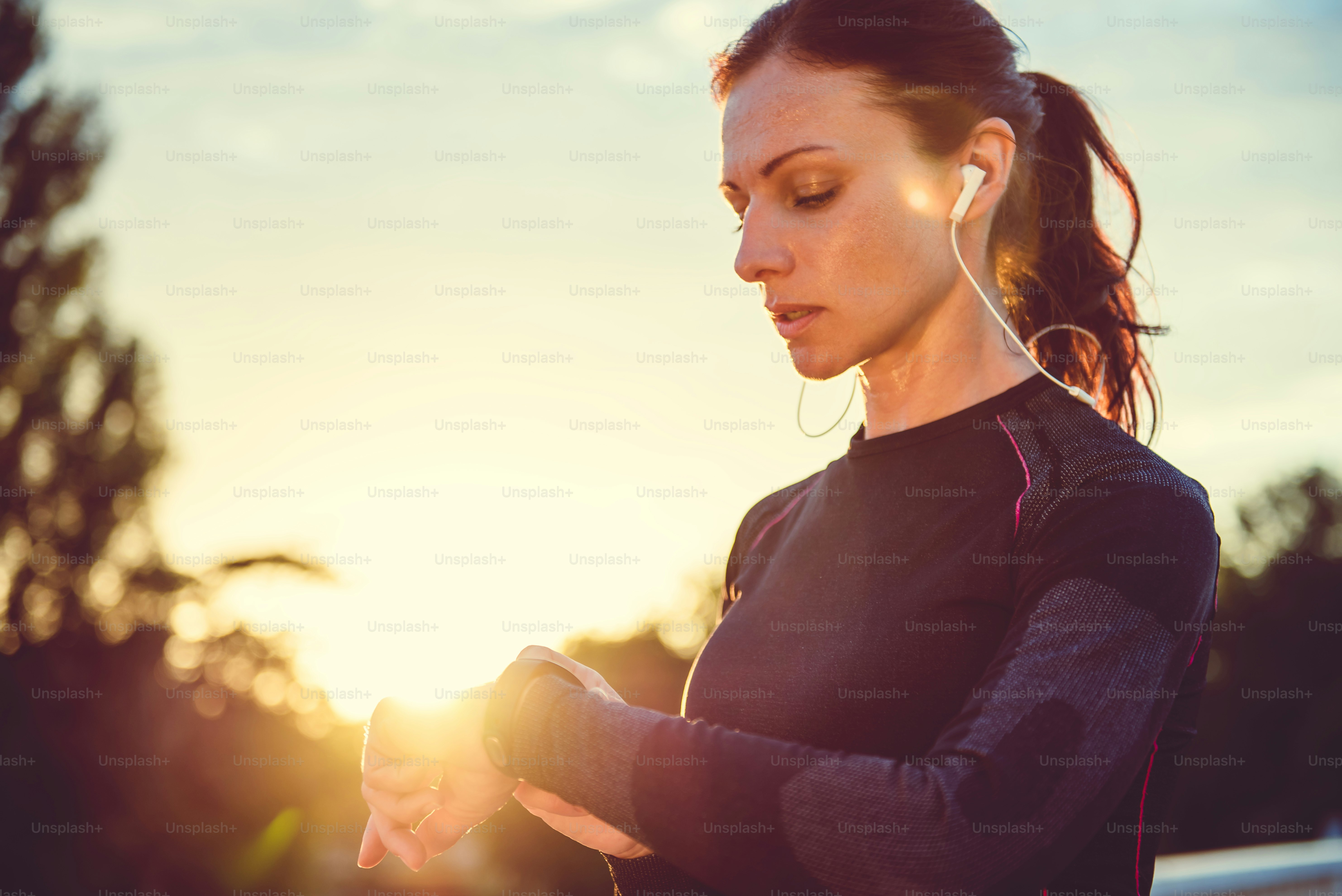 Woman monitoring her progress on smart watch photo – Brown hair Image ...