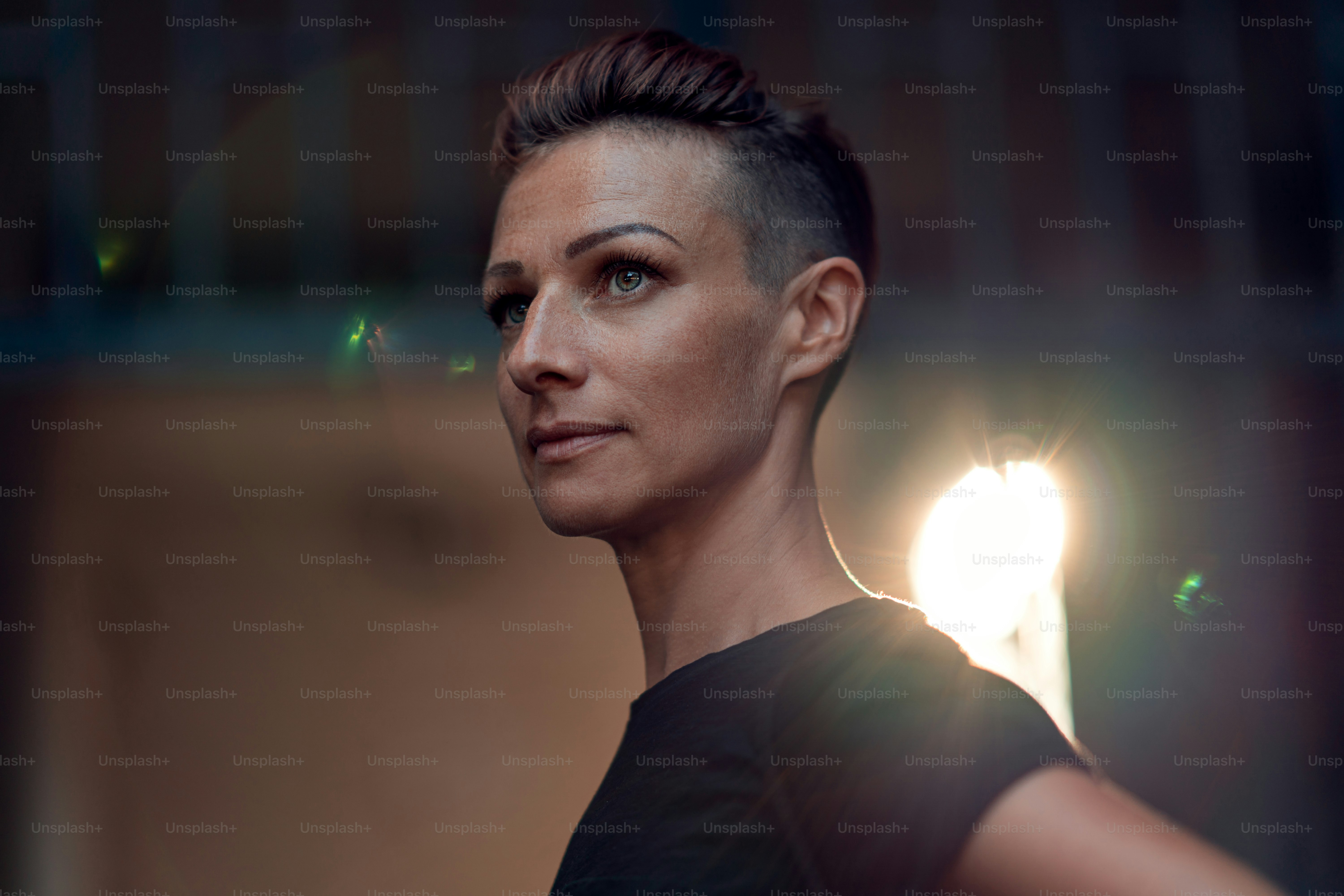 Portrait of woman with mohawk hairstyle standing in front of the building entrance