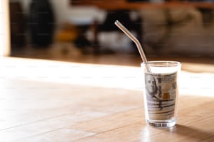 a glass with a straw in it sitting on a table