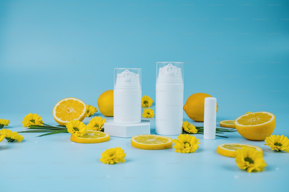 a table topped with lemons and a bottle of lotion