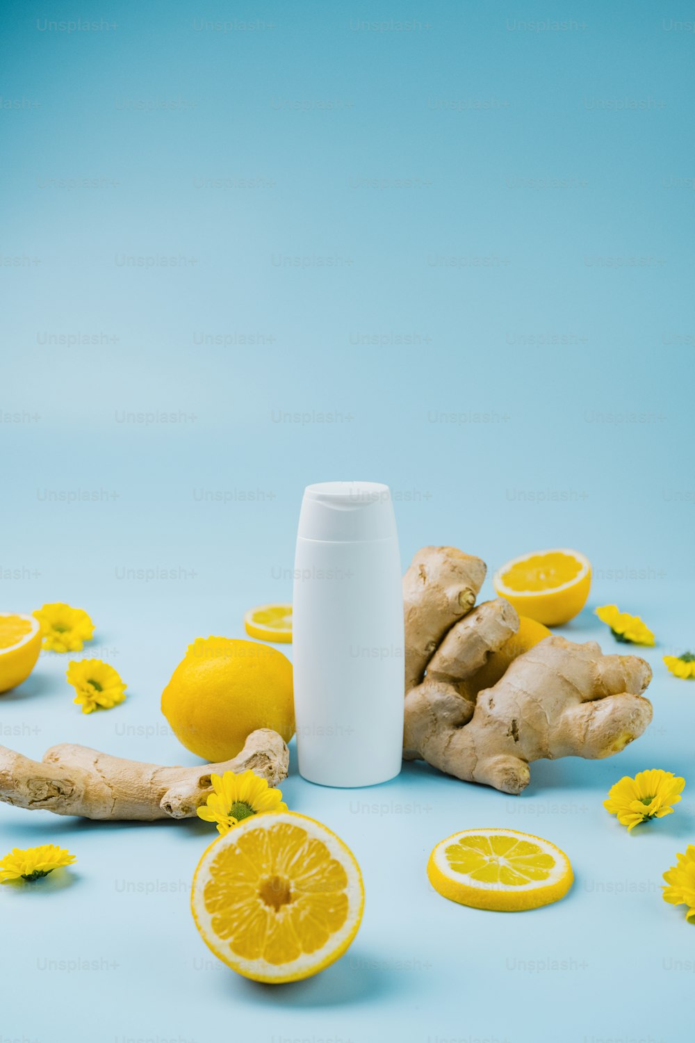 a tube of deodorant surrounded by lemons and ginger