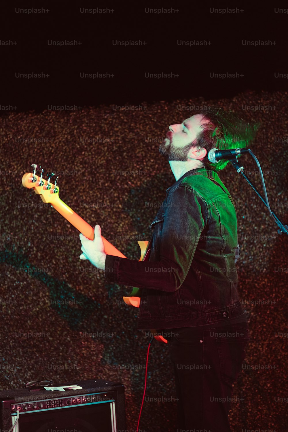 a man with a beard playing a guitar