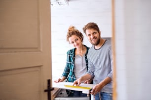 Small business of a young couple. Man and woman worker in the carpenter workroom.