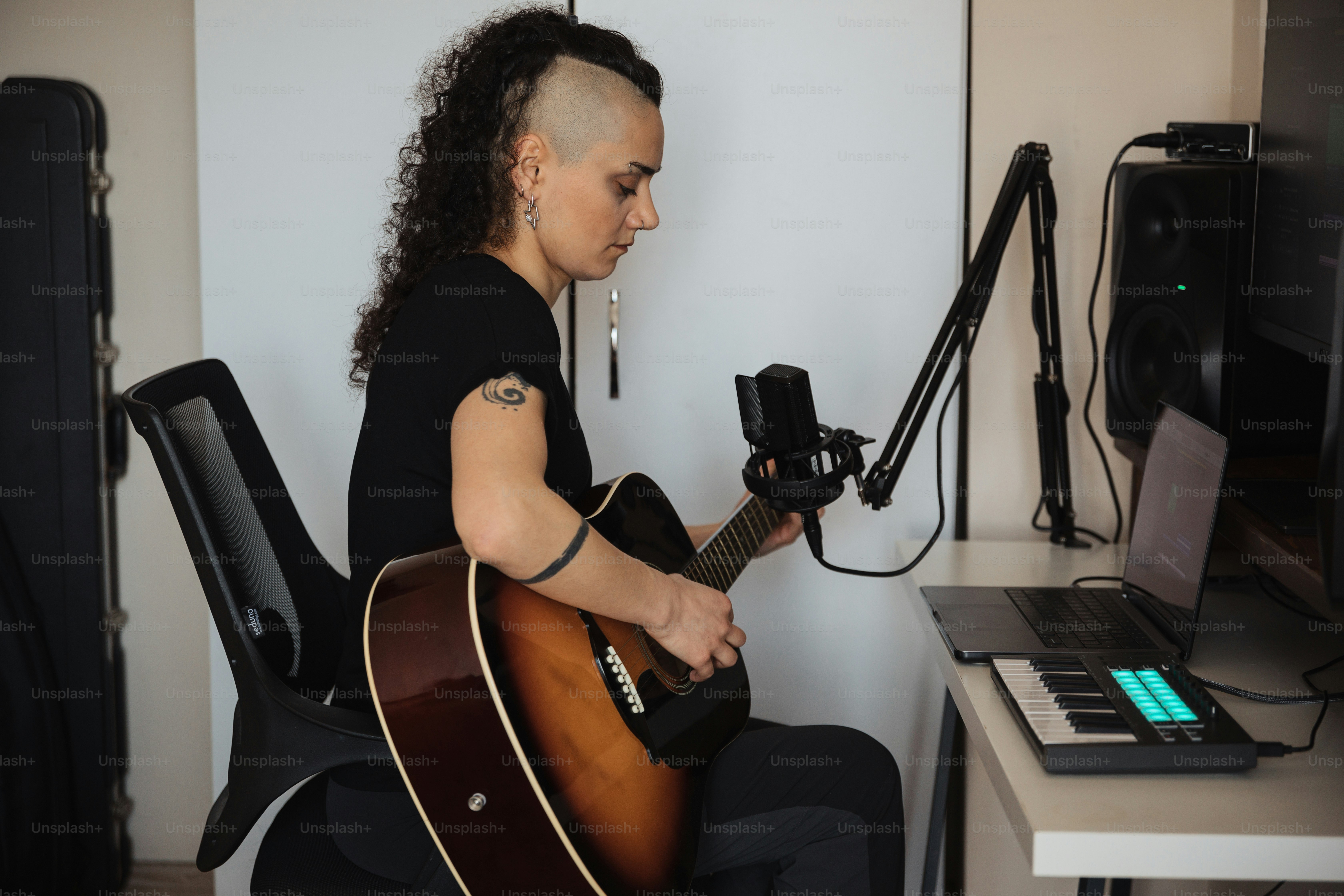 a woman sitting in a chair playing a guitar
