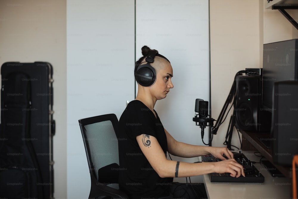 a woman sitting at a desk with headphones on