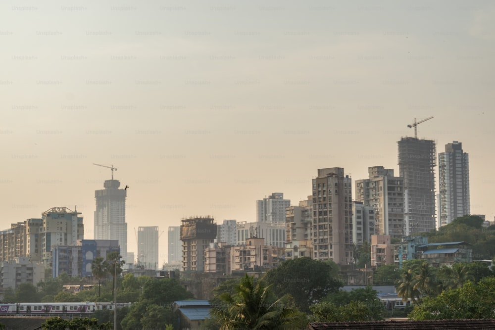 a city skyline with a train on the tracks