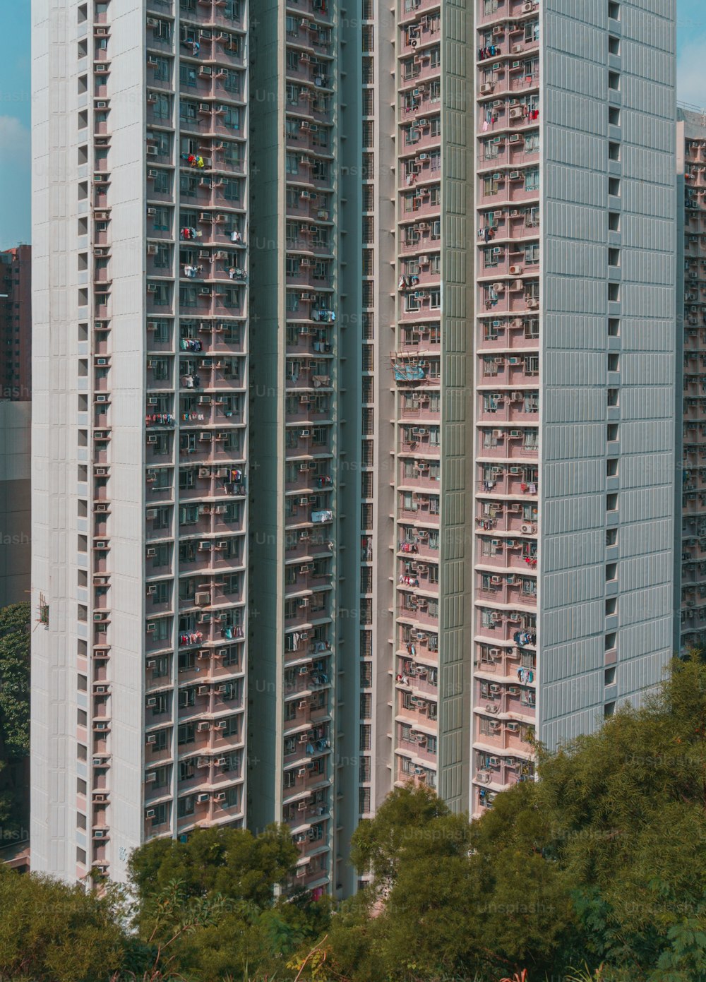 a tall building with many balconies in front of it