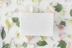 a square piece of paper surrounded by flowers