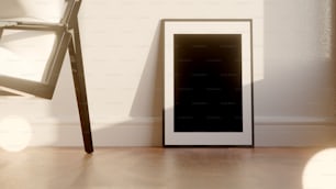 an empty picture frame sitting next to a chair