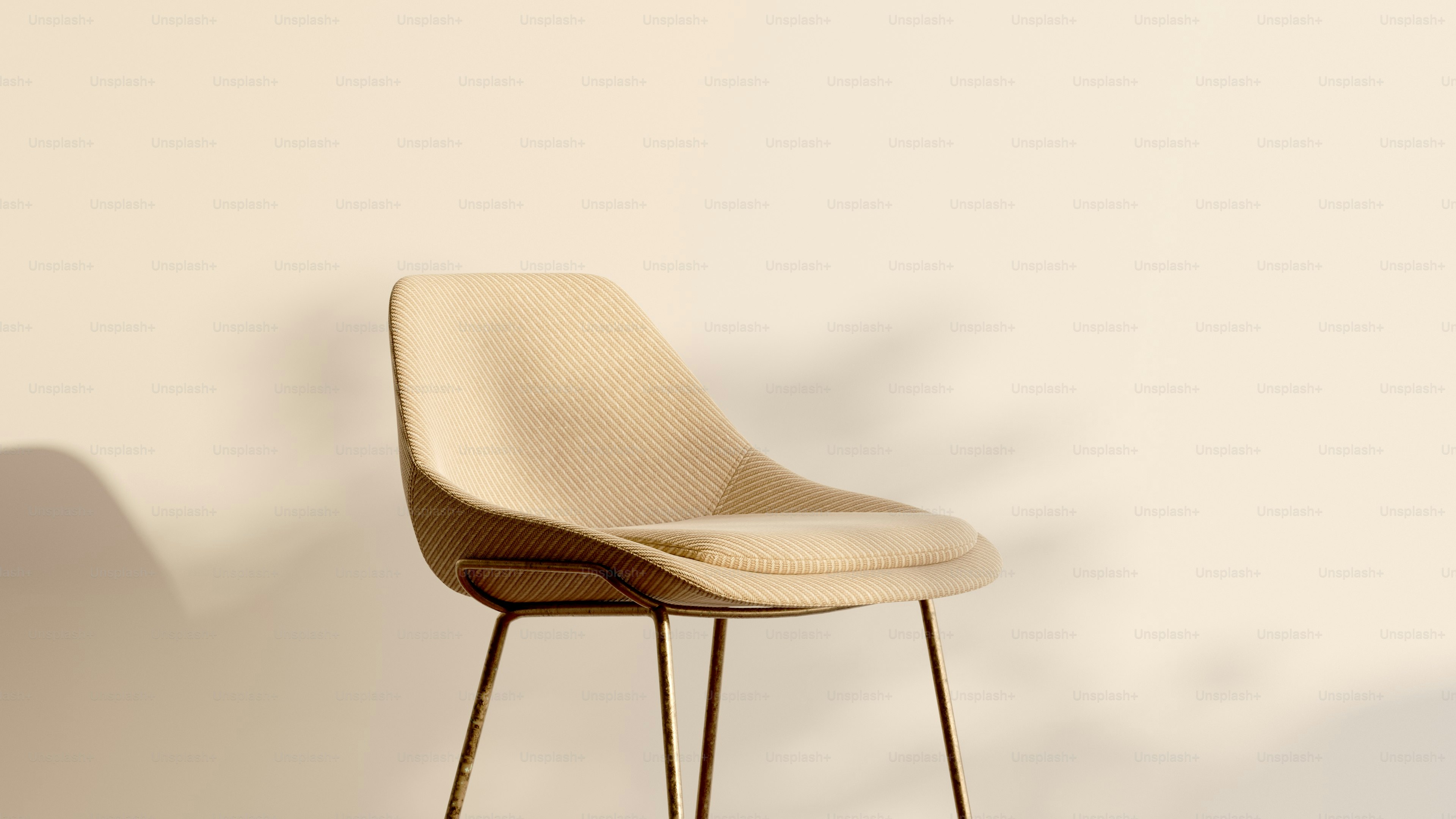 a beige chair with a black metal base