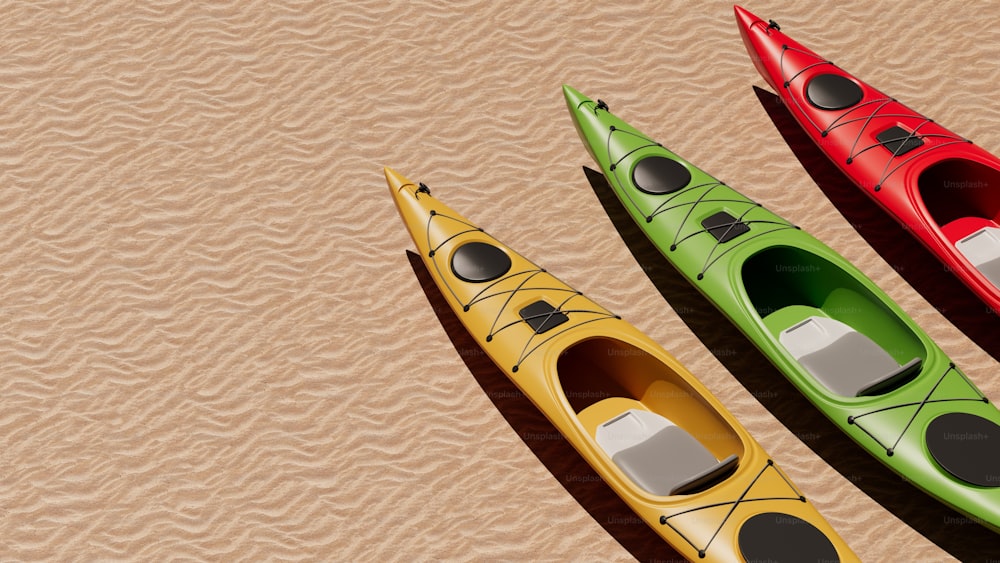 three kayaks lined up on a sandy beach