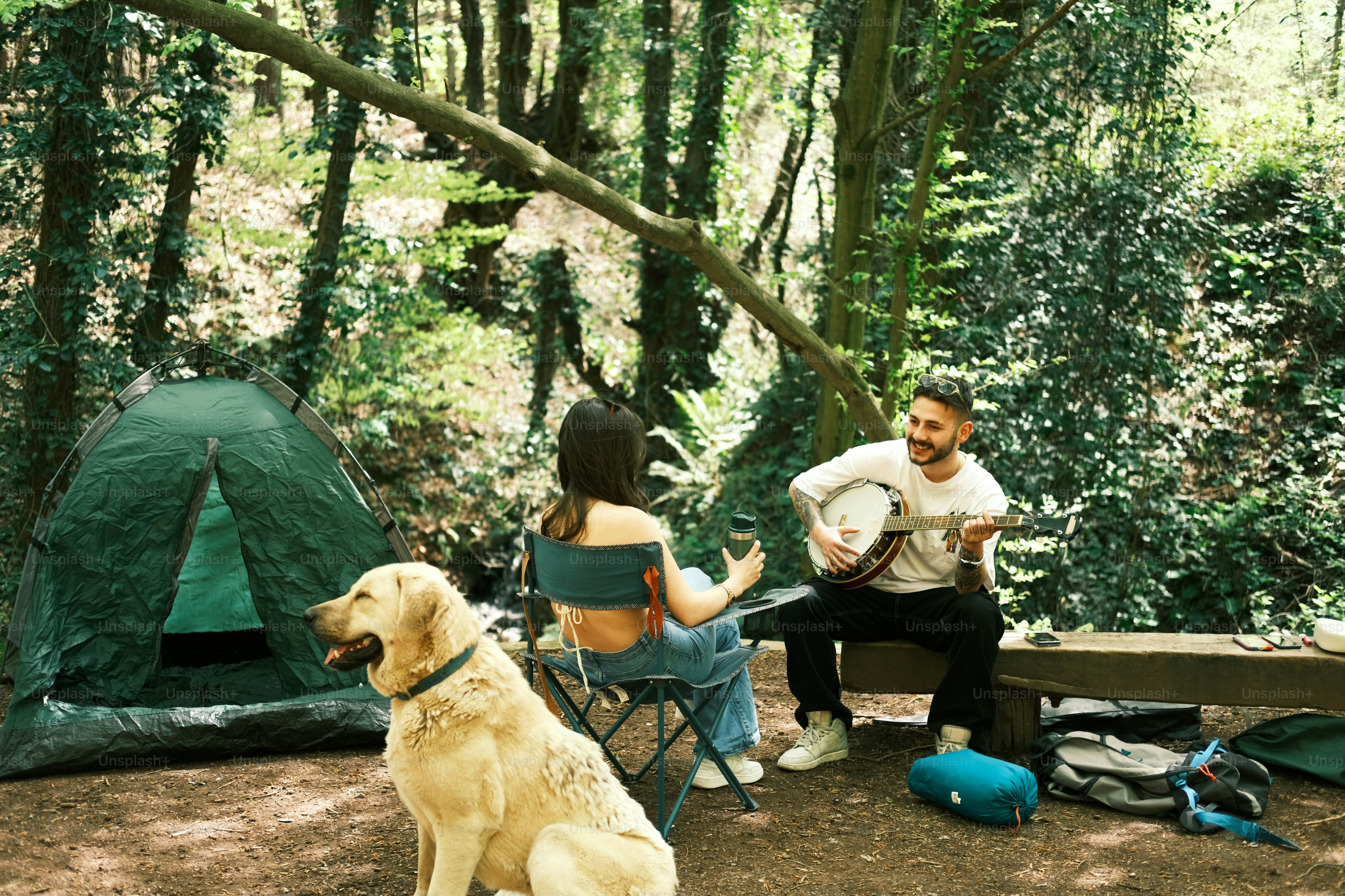 a man and a woman sitting next to a dog