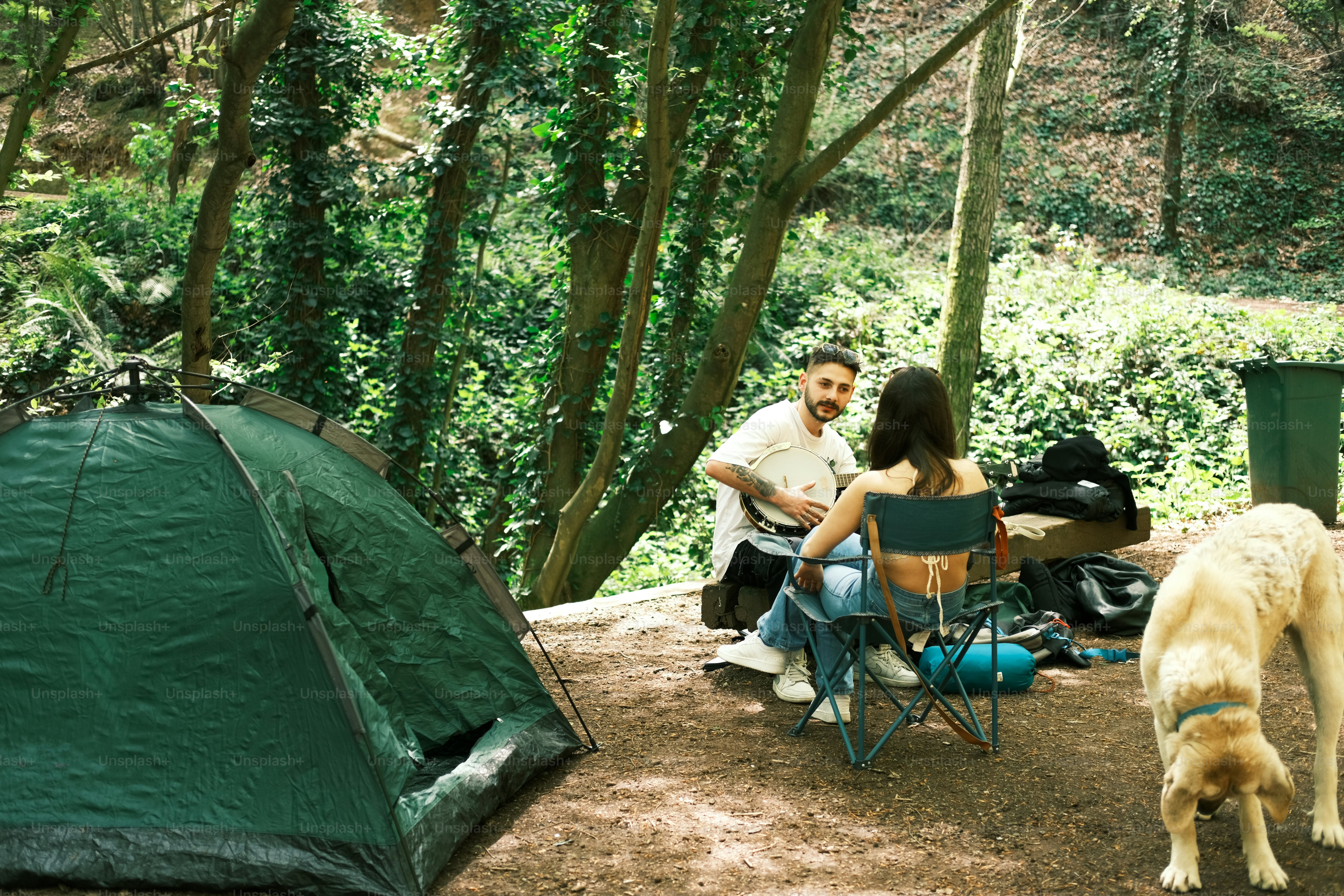 a man and a woman sitting at a table next to a tent