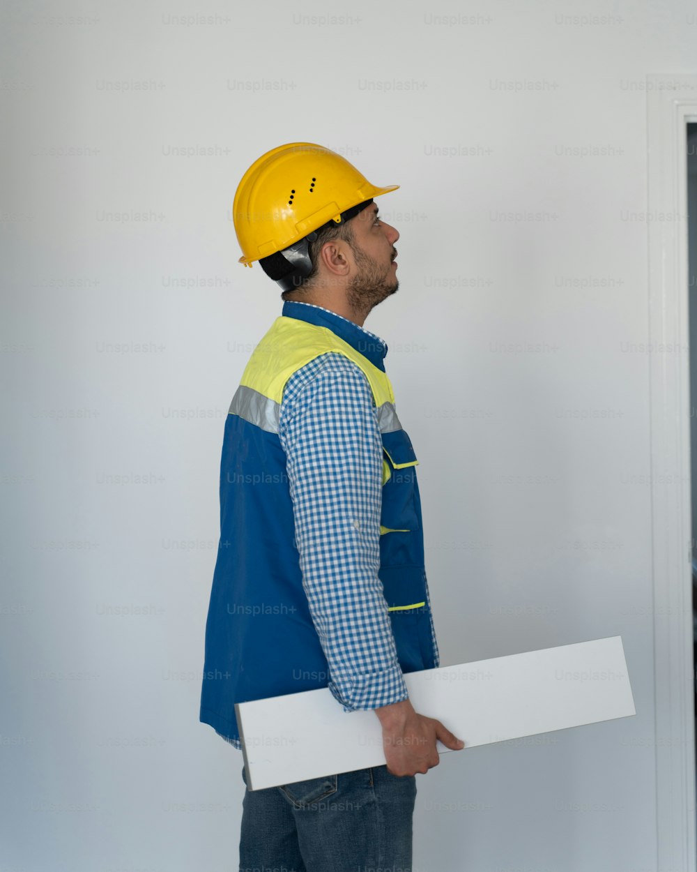 a man in a hard hat holding a piece of paper