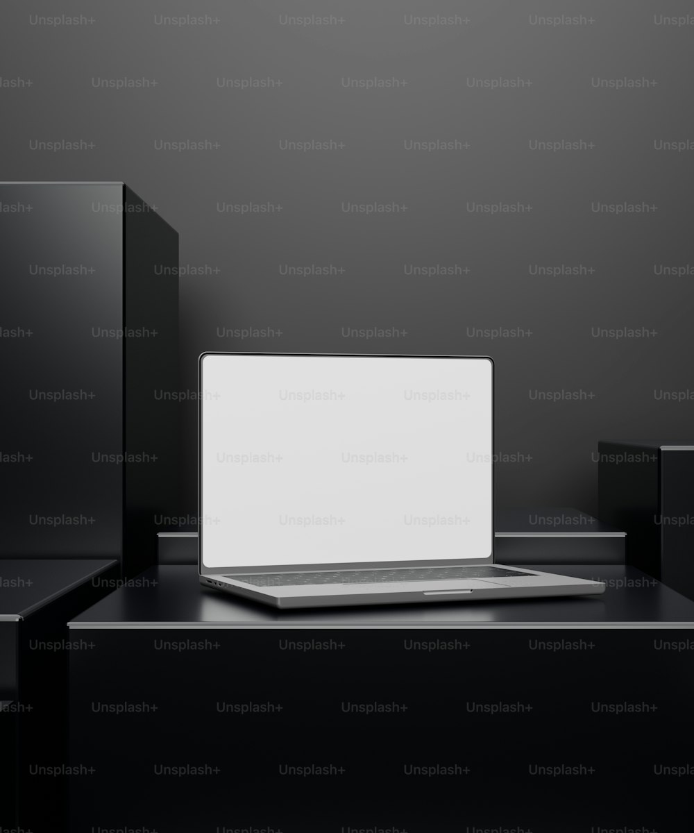 a laptop computer sitting on top of a black table