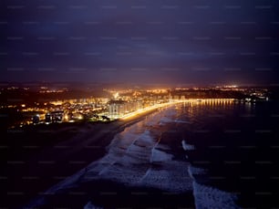 a night view of a beach and city lights