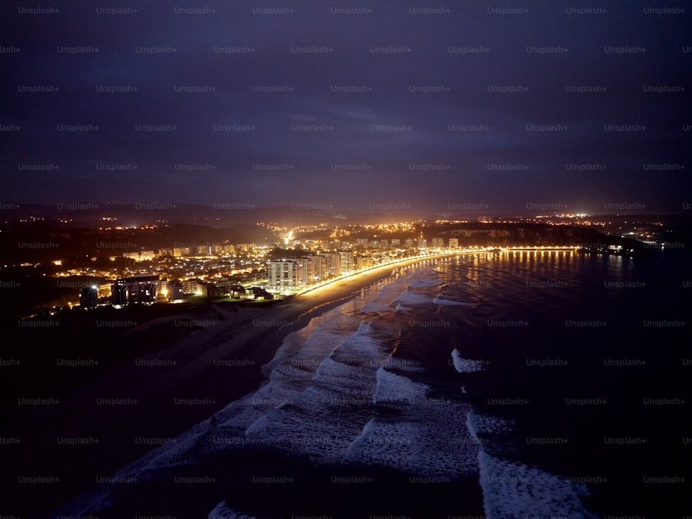 a night view of a beach and city lights