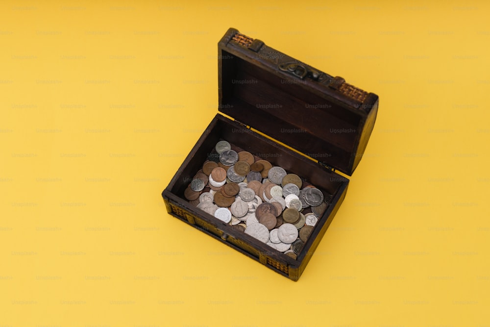 a wooden box filled with lots of coins