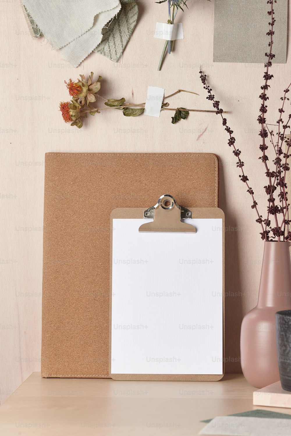 a clipboard with a clipboard attached to it next to a vase with flowers