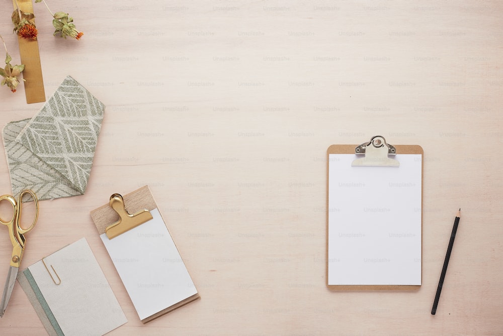 a clipboard with a notepad and a pen on it