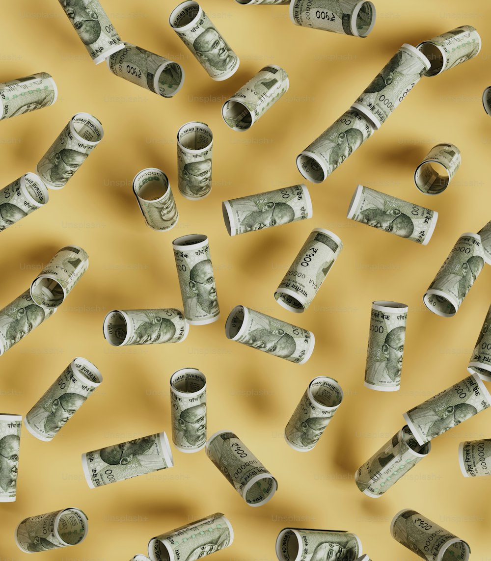 a bunch of rolled up money sitting on top of a table
