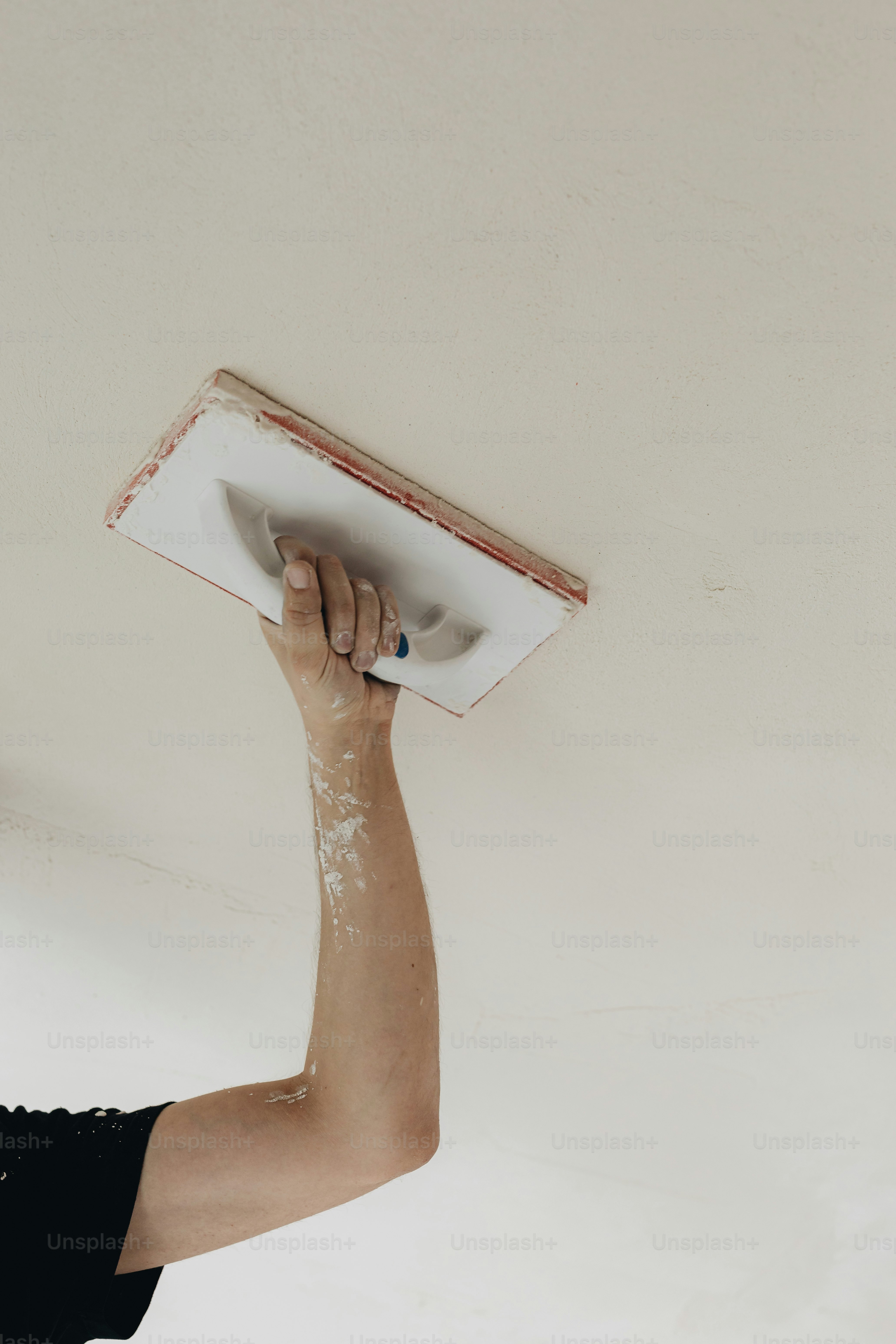 a man in a black shirt and a white ceiling fan