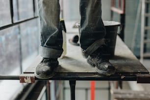 a person standing on top of a metal table