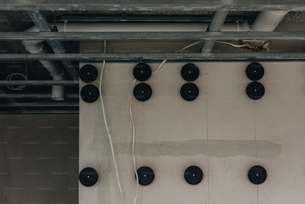 a group of black speakers hanging from a ceiling