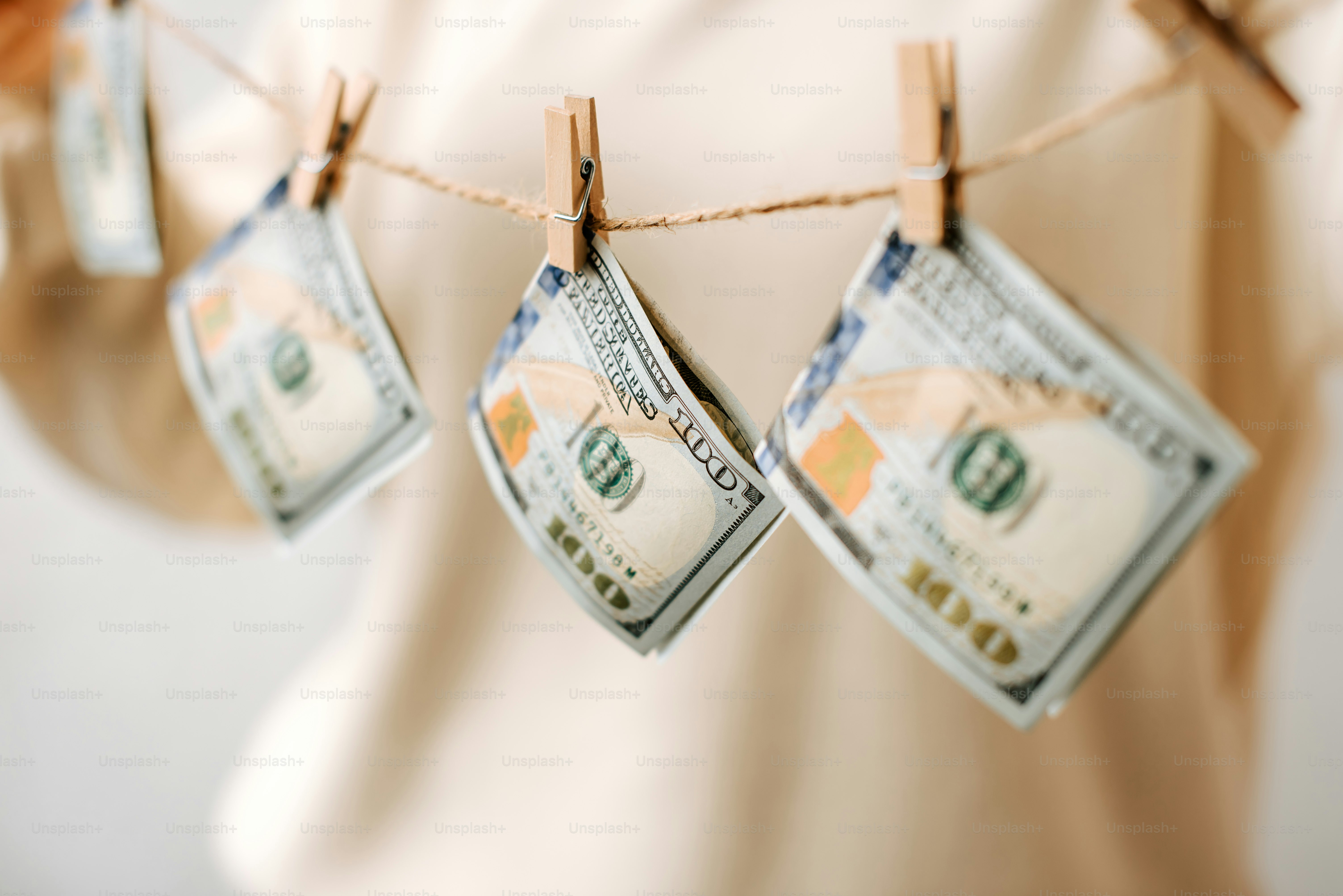 a person hanging money on a clothes line