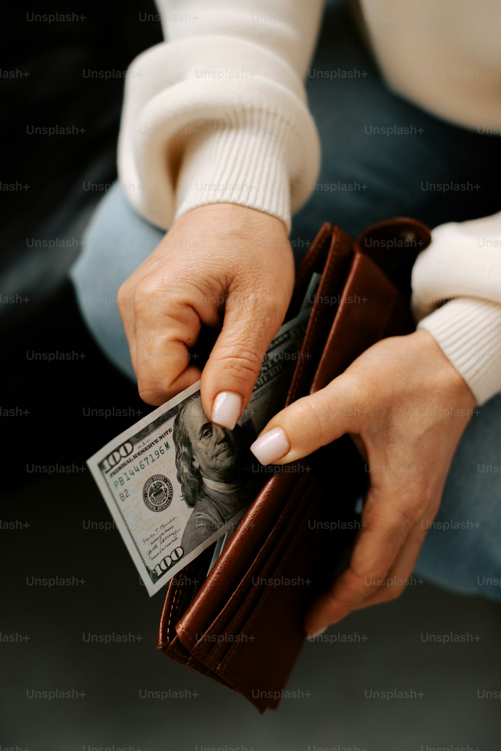 a woman is holding a wallet and money
