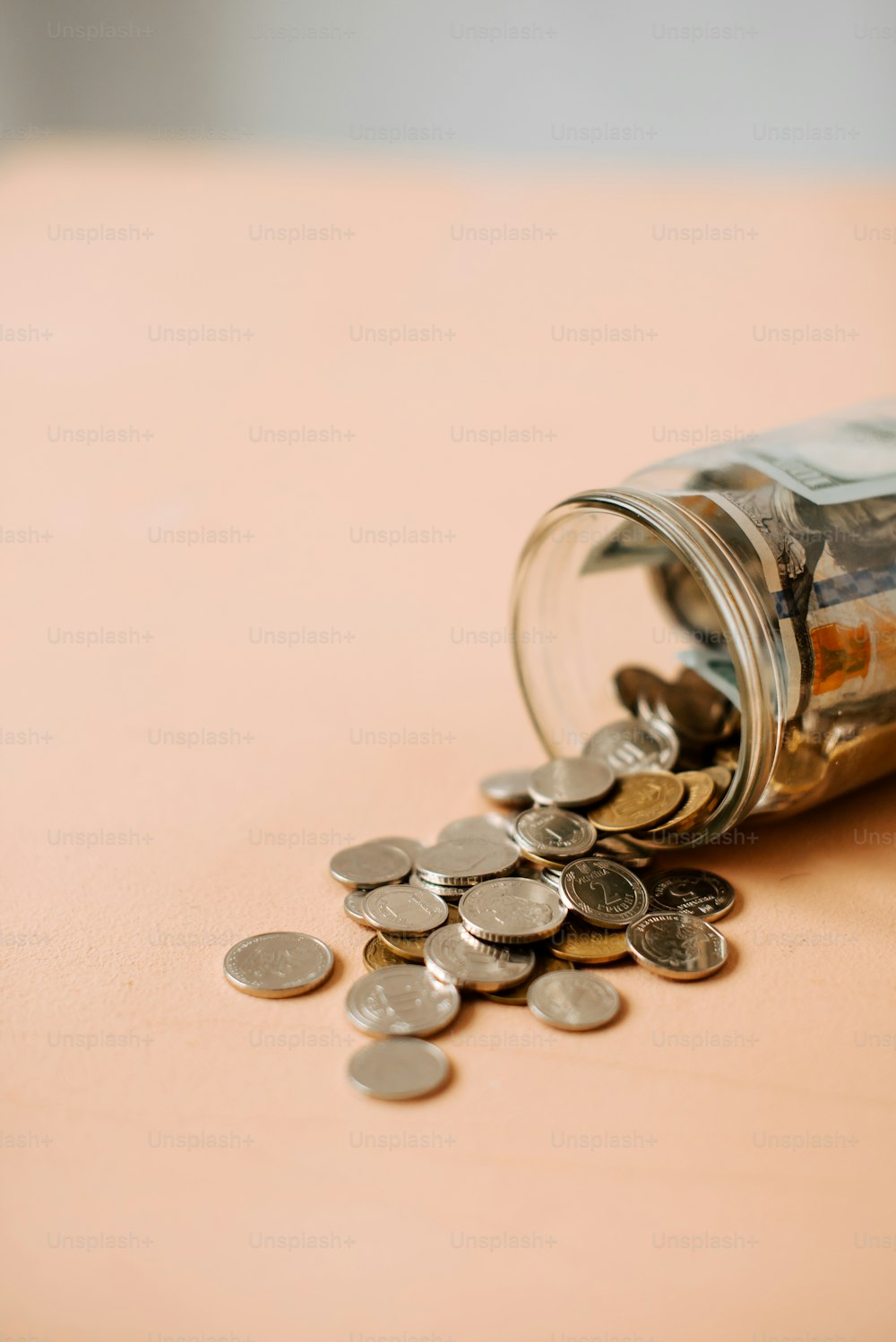 a glass jar filled with money sitting on top of a table