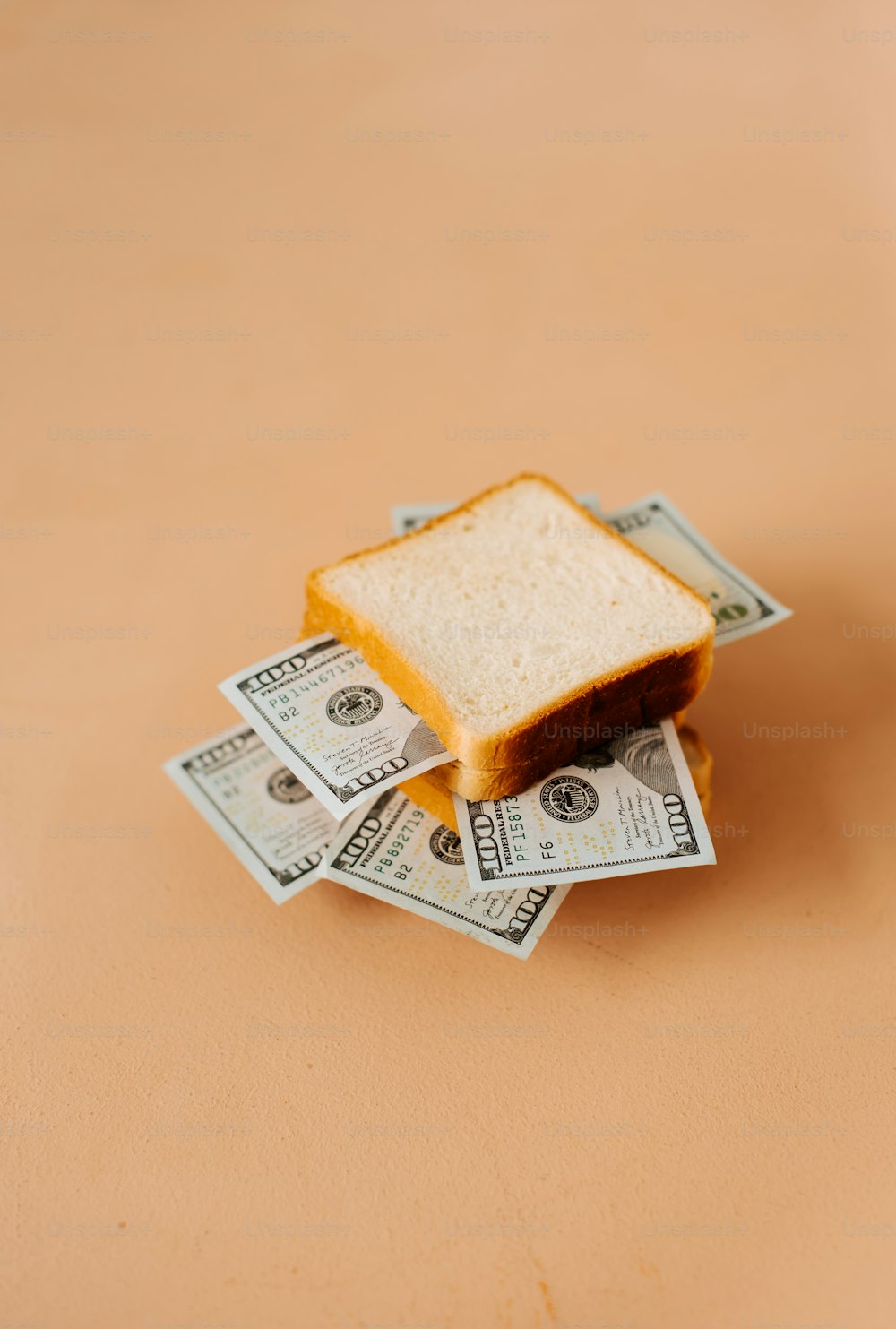 a toasted sandwich sitting on top of a pile of money