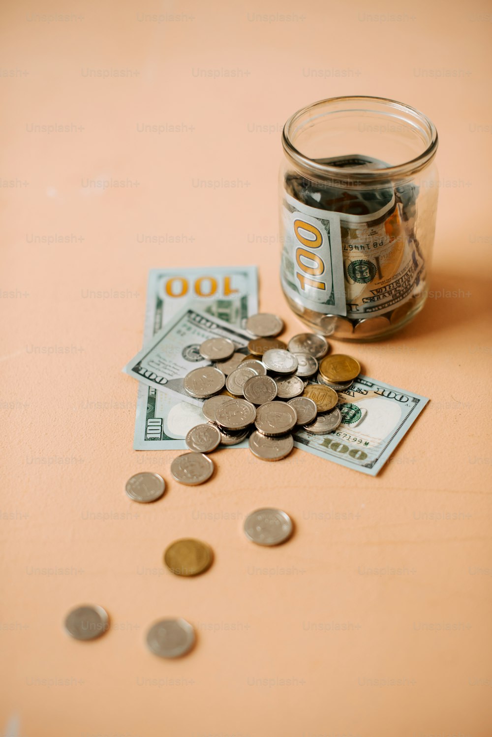 a glass jar filled with money sitting on top of a table