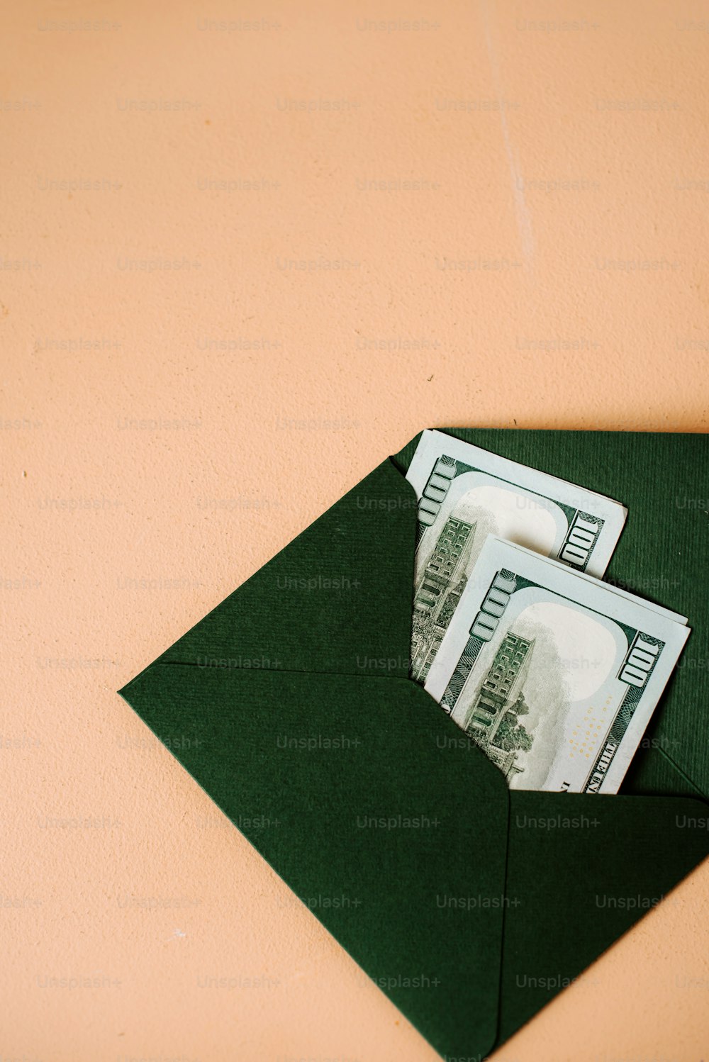 a green envelope with money sticking out of it