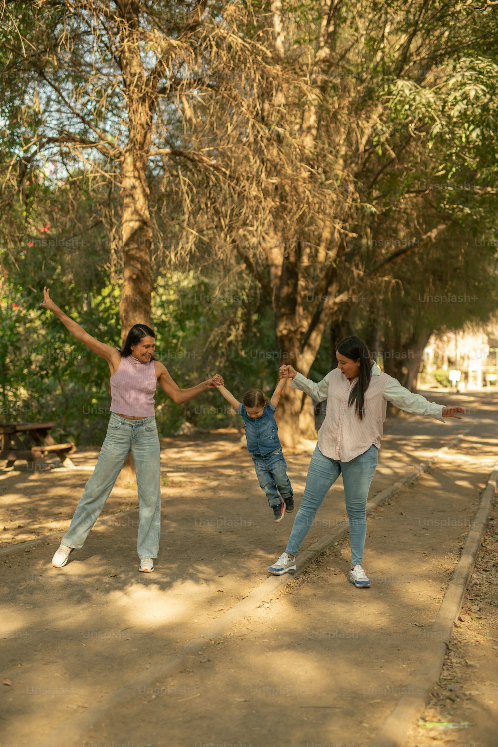 a woman and two children playing with a frisbee