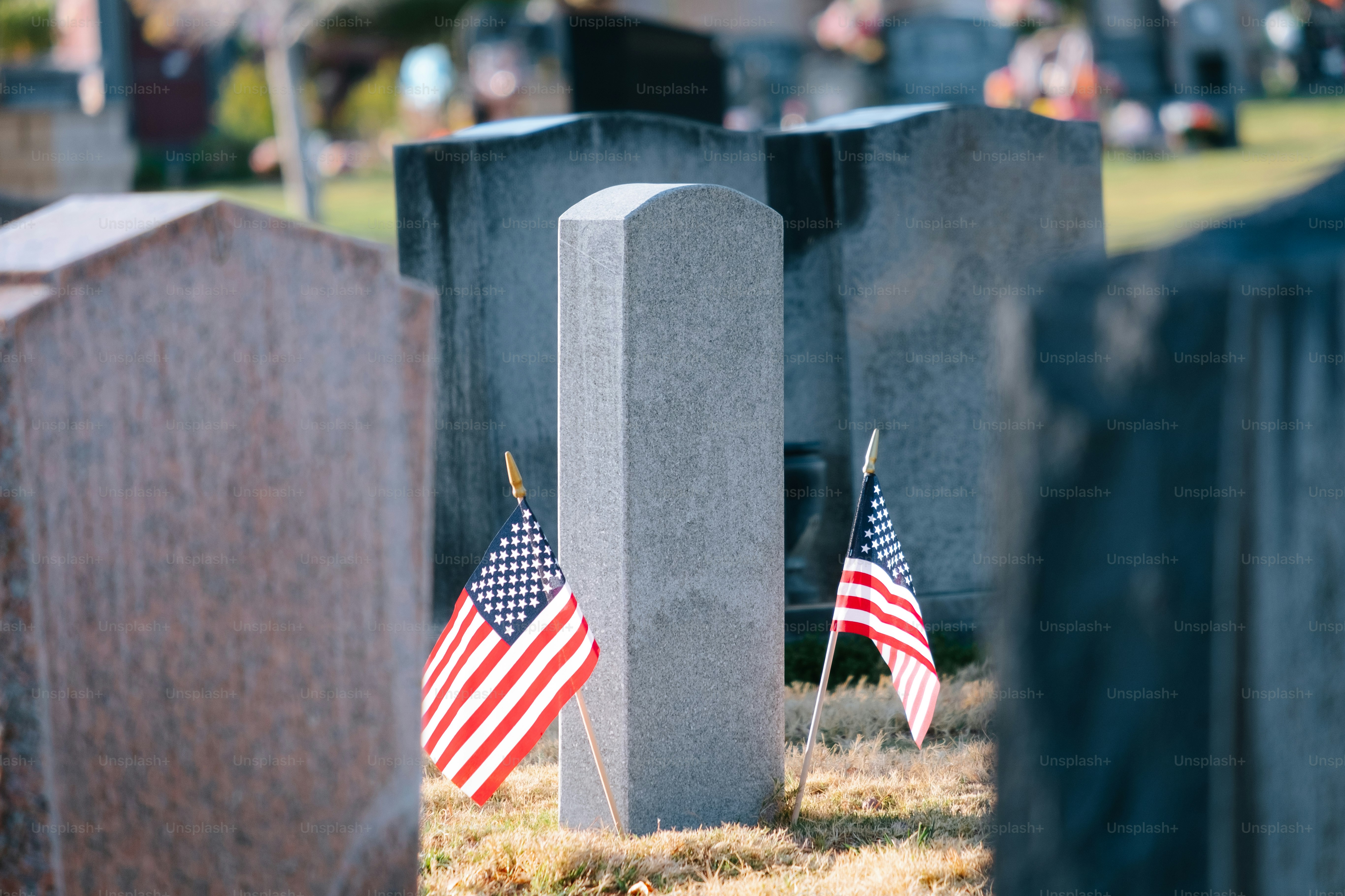 Un cimetière avec des drapeaux américains sur les pierres tombales