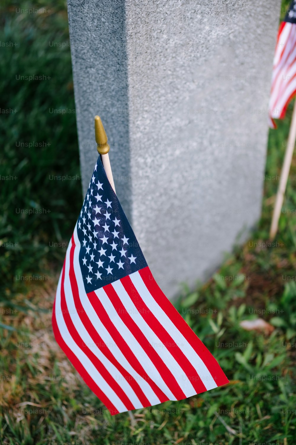 an american flag is hanging on a grave