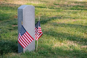 a grave with two american flags on it