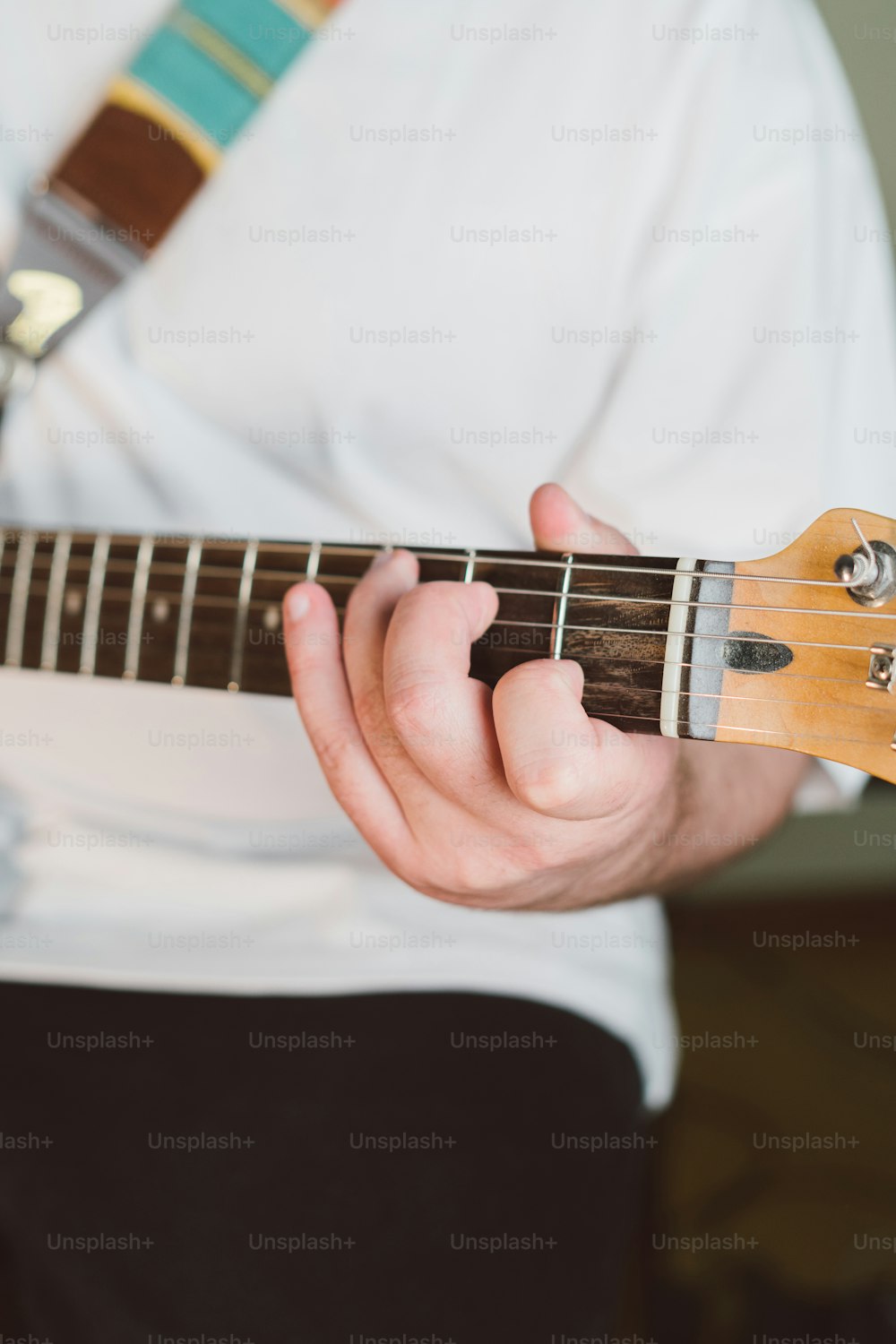 a person holding a guitar in their hands