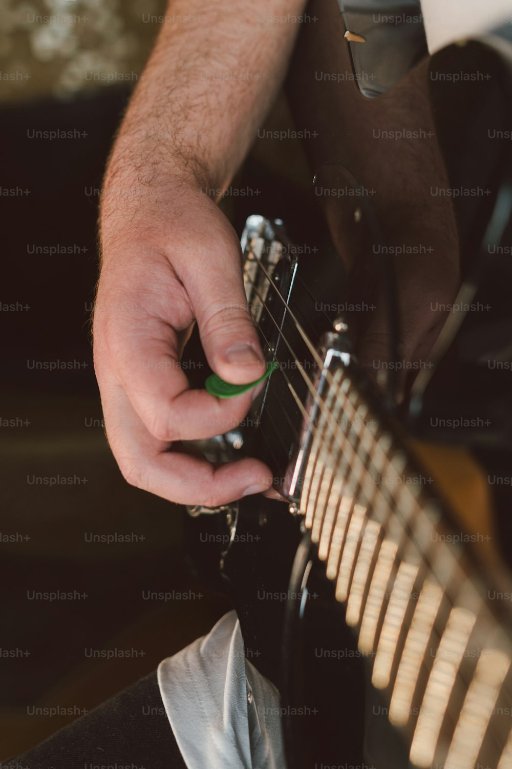 a close up of a person playing a guitar