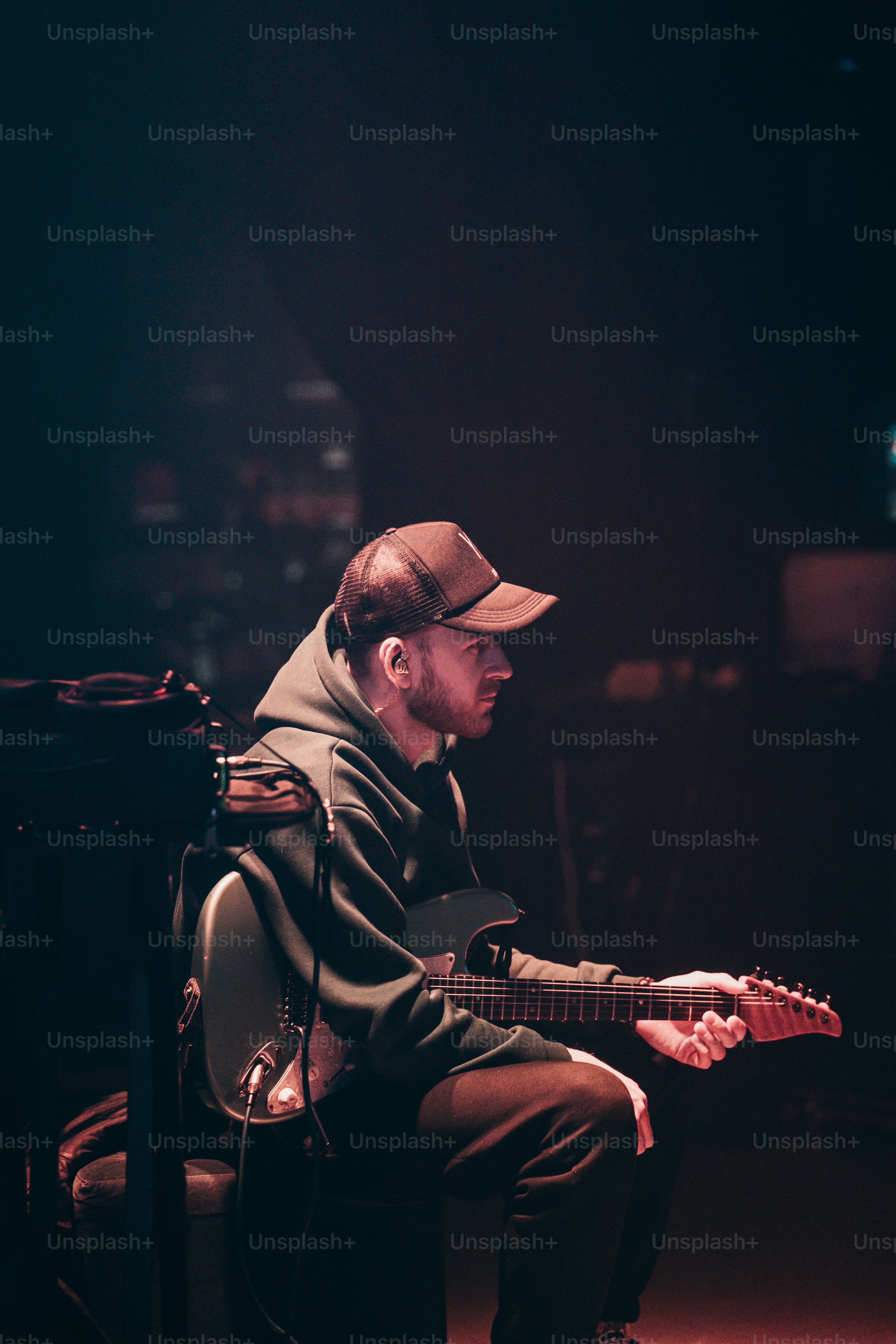 A man sitting in a chair playing a guitar photo – Music Image on Unsplash